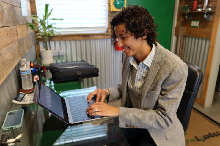 woman (lady perez) at a desk on her laptop