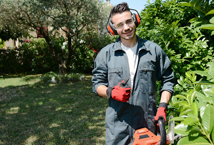 Man with protective eye gear and lawn equipment